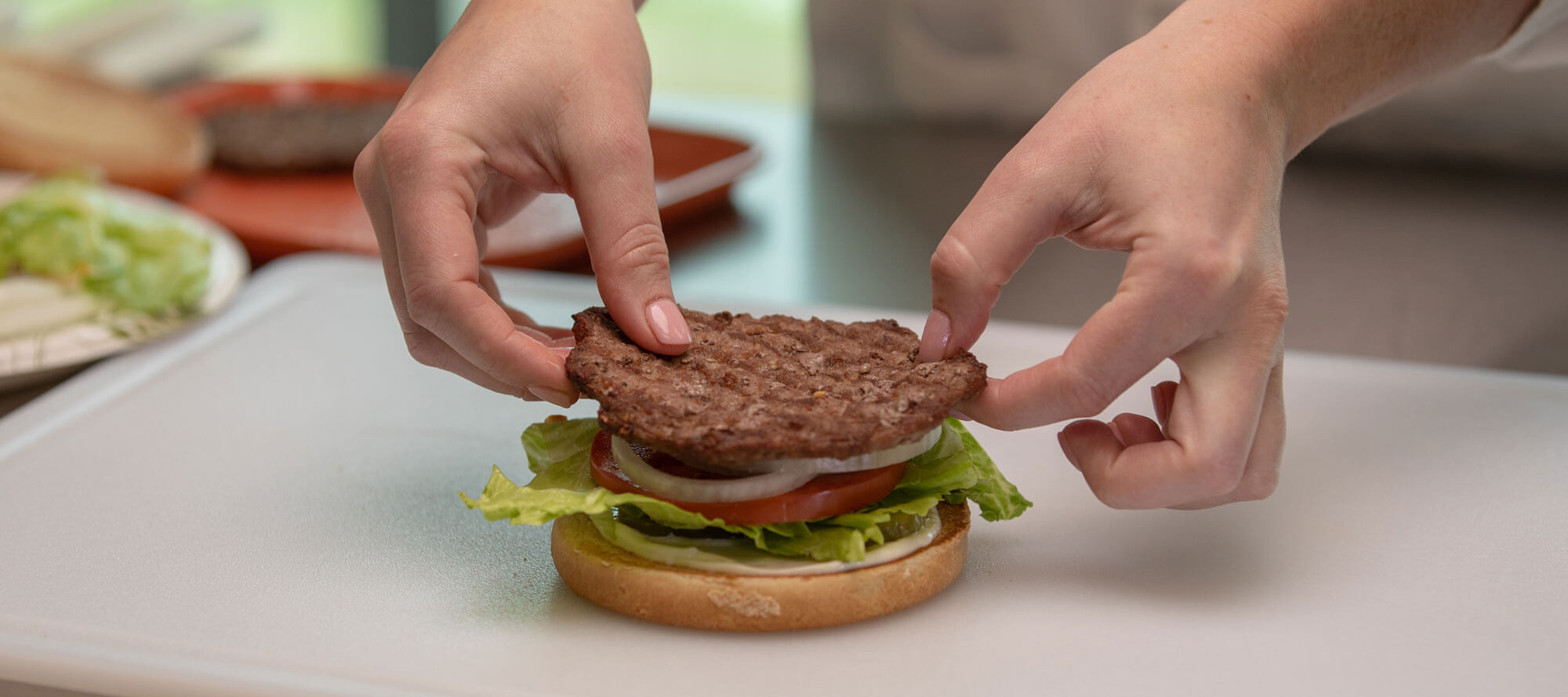 Carl's Jr. worker assembling burger